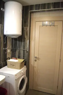 a bathroom with a toilet and a sink and a door at Yeshill Homes in Budva