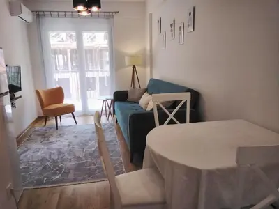 a living room with a blue couch and a table at Yeshill Homes in Budva