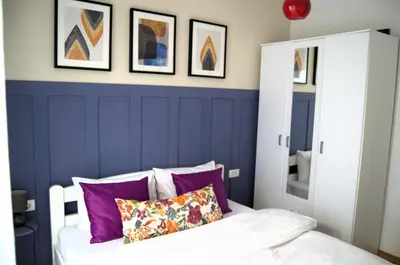 a bedroom with purple walls and a bed with purple pillows at Yeshill Homes in Budva