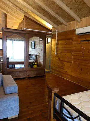 a room with wooden walls and a bed and a window at Masa L13 Stasa L14 in Ulcinj
