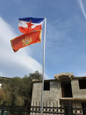 a flag flying in front of a building at Apartmen Kuca za odmor i familiju in Bar