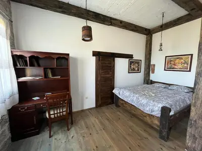 a bedroom with a bed and a desk at Bed & Wine Djonovic in Virpazar