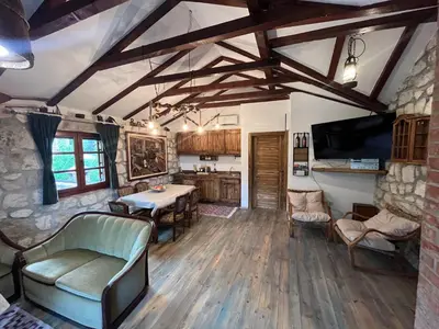 a living room with a table and a tv at Bed & Wine Djonovic in Virpazar