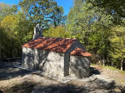a small brick building with a red roof at Bed & Wine Djonovic in Virpazar