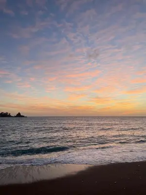 a sunset on the beach with the ocean at Просторная квартира в Петровце с видом на море in Petrovac na Moru