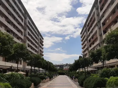 an empty street between two tall apartment buildings at Apartment in Central Point in Podgorica