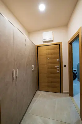 a hallway with a wooden door in a room at Elite apartments Podgorica in Podgorica