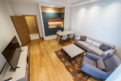 a living room with a couch and a table at Elite apartments Podgorica in Podgorica