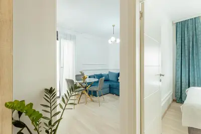 a living room with a blue couch and a table at Miracle apartment in Kotor