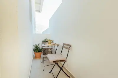 a small table and chairs in a room with a window at Miracle apartment in Kotor