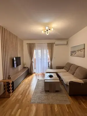 a living room with a couch and a table at Stylish charming apartment in Podgorica