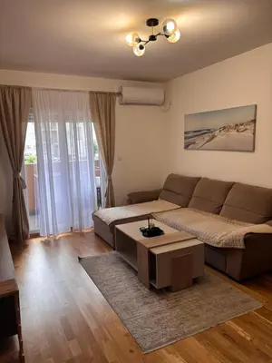 a living room with a couch and a coffee table at Stylish charming apartment in Podgorica