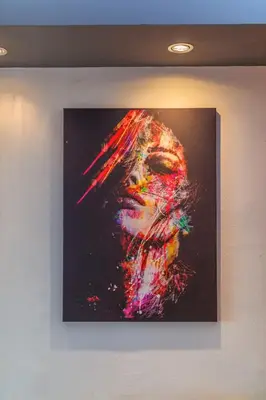 a painting of a woman on a wall at Beni Apartment in Bar