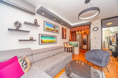 a living room with a couch and a table at Beni Apartment in Bar