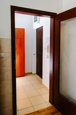 a hallway with a door and a tile floor at Stex Urban 1 in Podgorica