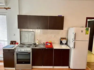a kitchen with a stove and a refrigerator at Stex Urban 1 in Podgorica