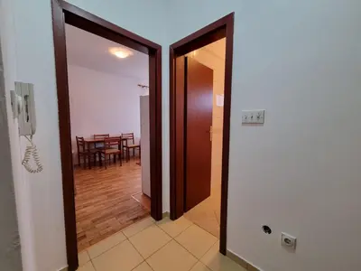 a hallway with a door leading to a dining room at Stex Urban 1 in Podgorica