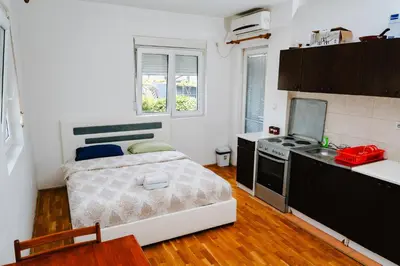 a small kitchen with a bed in a room at Stex Urban 1 in Podgorica