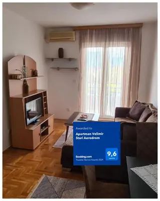 a living room with a couch and a television at Apartman Velimir Stari Aerodrom in Svijetin Brijeg