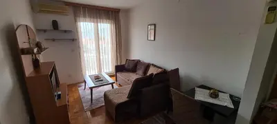 a living room with a couch and a window at Apartman Velimir Stari Aerodrom in Svijetin Brijeg