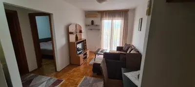 a living room with a couch and a television at Apartman Velimir Stari Aerodrom in Svijetin Brijeg
