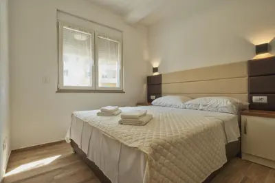 a bedroom with a bed with two towels on it at El Pasaja in Dobra Voda