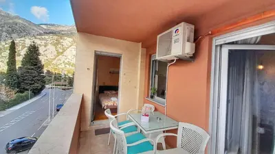 a small balcony with a table and chairs and a window at Sea view apartment in Kotor ! Apartment Popica in Kotor
