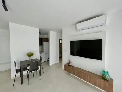 a living room with a large flat screen tv on a wall at Solaris Lux Apartments in Kotor