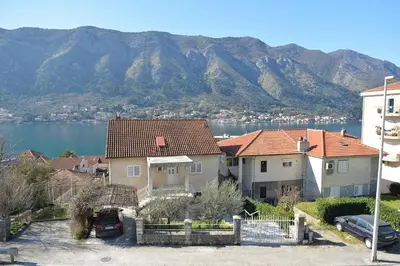 a group of houses with mountains in the background at Solaris Lux Apartments in Kotor