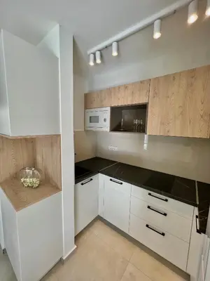 a kitchen with white cabinets and a microwave at Solaris Lux Apartments in Kotor