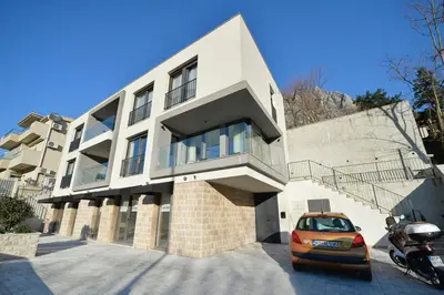 a building with a car parked in front of it at Solaris Lux Apartments in Kotor