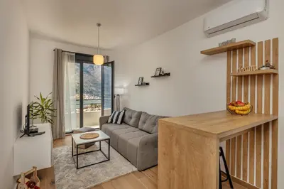 a living room with a couch and a table at LANA Sea View Apartment in Kotor