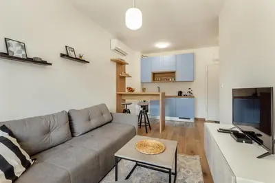a living room with a couch and a table at LANA Sea View Apartment in Kotor