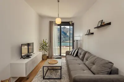 a living room with a couch and a table at LANA Sea View Apartment in Kotor