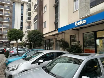 a row of parked cars parked in front of a building at Delta apartment City kvart in Podgorica