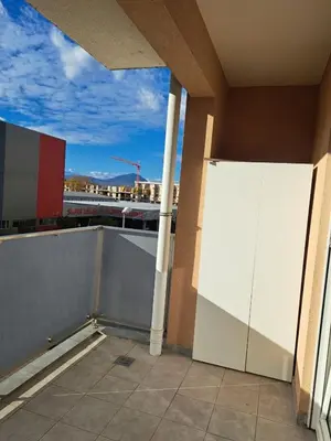 a balcony of a building with a white wall at Delta apartment City kvart in Podgorica