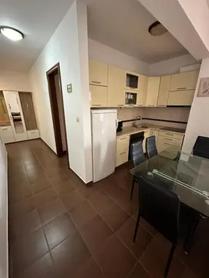 a kitchen with a glass table and a refrigerator at Vanilla Apartment Petrovac in Petrovac na Moru