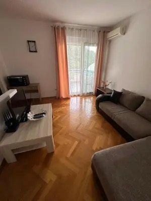 a living room with a couch and a coffee table at Vanilla Apartment Petrovac in Petrovac na Moru