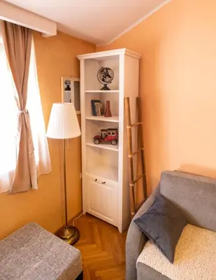 a bedroom with a book shelf with a toy car on it at Norandvik Apartment in Podgorica