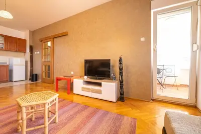 a living room with a flat screen tv sitting on a table at Norandvik Apartment in Podgorica