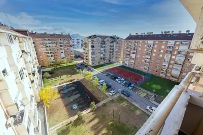 an aerial view of a parking lot in a city with buildings at Norandvik Apartment in Podgorica