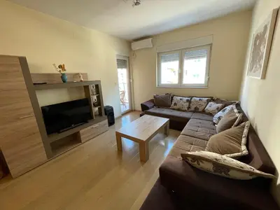 a living room with a couch and a tv at Apartment CK in Podgorica
