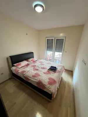 a bedroom with a bed with a quilt on it at Apartment CK in Podgorica