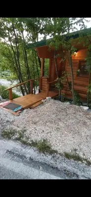 a wooden bench sitting in front of a cabin at Still cabin in Cetinje