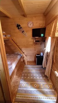 a room with a bed in a log cabin at Still cabin in Cetinje