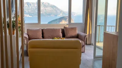 a couch in a living room with a view of a mountain at Viewpoint Villa in Budva