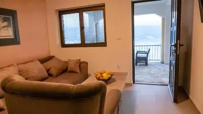 a living room with a couch and a table at Viewpoint Villa in Budva