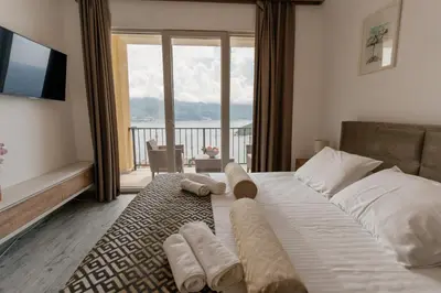 a bedroom with a large bed with a large window at Viewpoint Villa in Budva