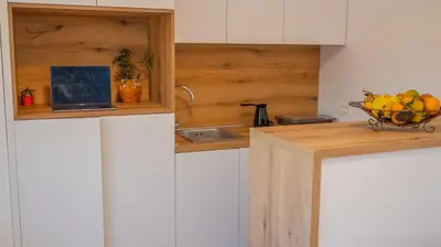 a kitchen with a bowl of fruit on a counter at Viewpoint Villa in Budva