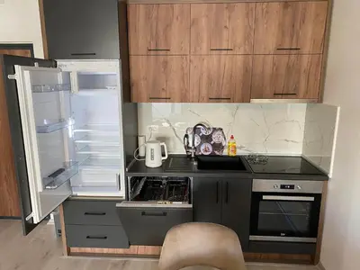 a small kitchen with an open refrigerator and a stove at Ulcinj Apartments in Ulcinj